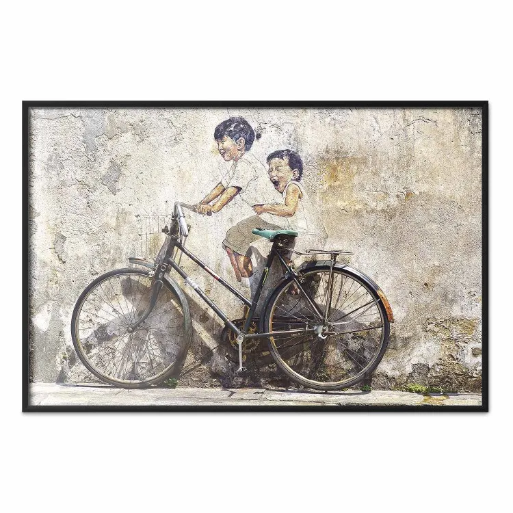 Carefree - retro black bicycle against a wall painted with children