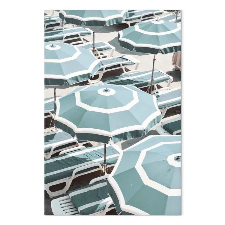 Turquoise sun loungers and umbrellas on the beach - seaside landscape