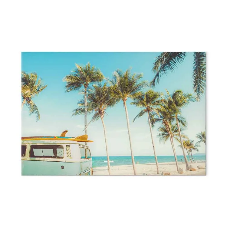 Surf camping - van with surfboards on a tropical beach