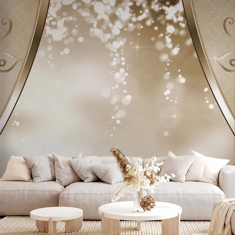 Golden abstraction - delicate ornaments on a background with a glowing light effect